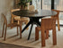 Round oak dining table with charcoal finish and arched frame, perfect for modern dining rooms.