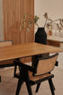 Rectangular oak dining table with natural finish and V-frame design, ideal for contemporary dining rooms.