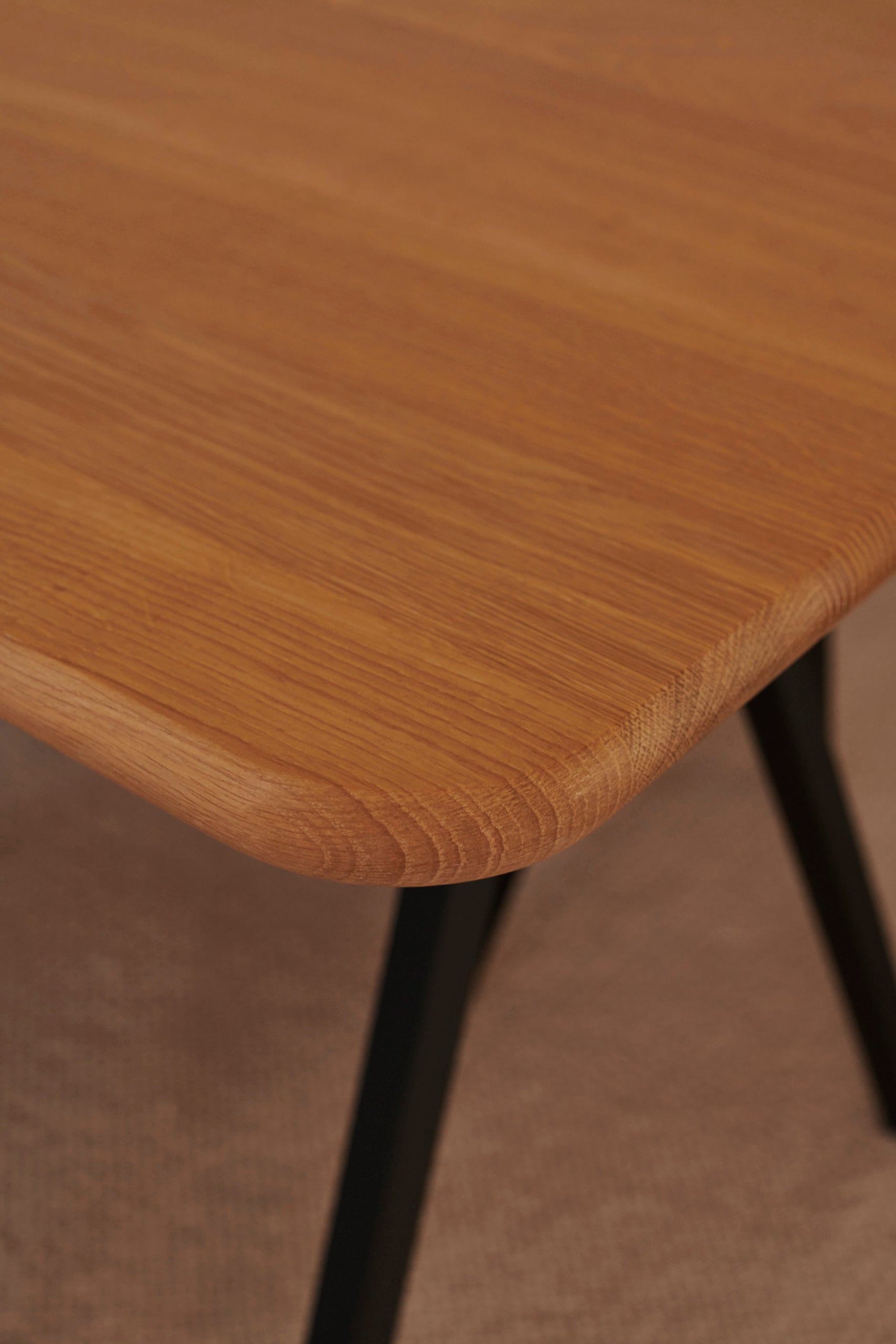 Rectangular oak dining table with natural finish and V-frame design, ideal for modern dining rooms.