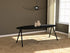 Oval oak dining table in charcoal finish with V-frame design, showcasing a sleek, modern dining surface.