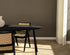 Oval oak dining table with charcoal finish and V-frame design, featuring a sleek, modern style for contemporary dining spaces.