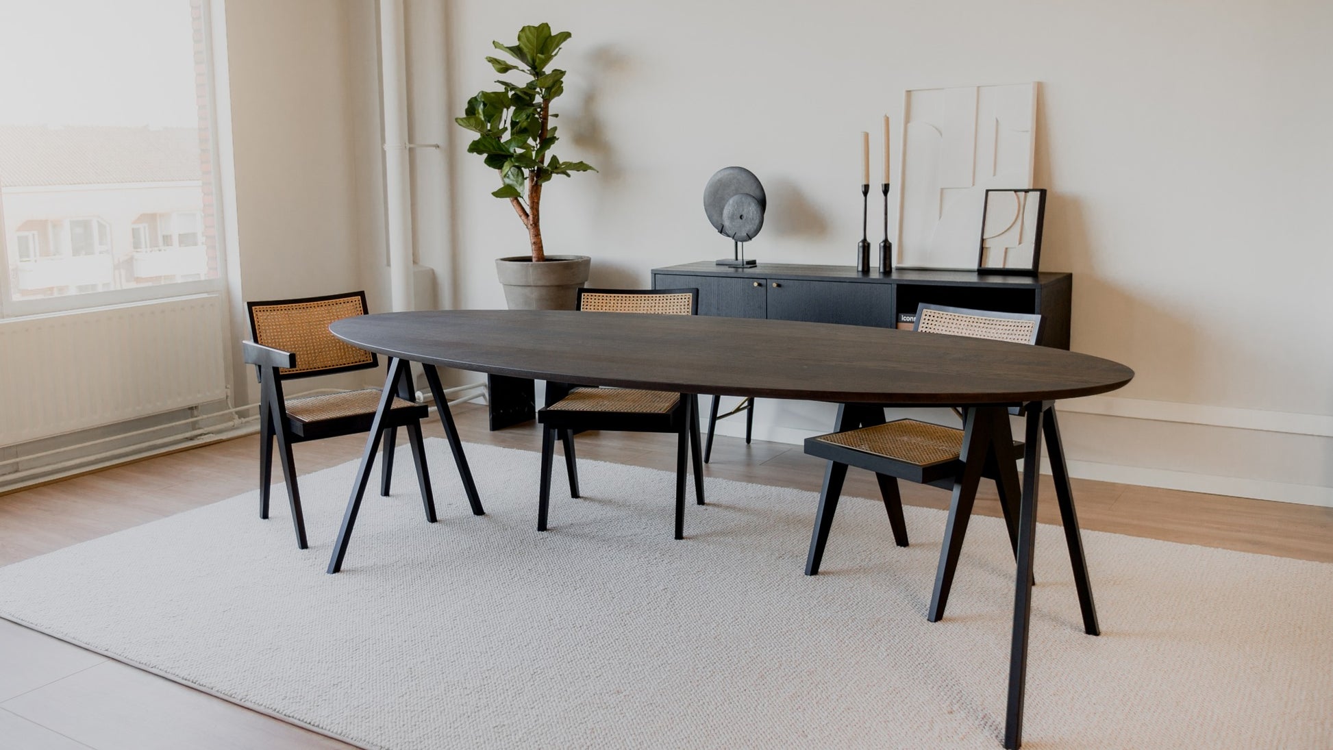 Oval walnut dining table with V-frame legs, 160 cm long, showcasing a smooth wooden surface and modern design.