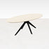 Oval oak dining table with ash white finish and arched frame, showcasing a sleek and modern design.