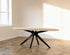 Oval oak dining table with ash white finish and arched frame, showcasing a sleek and modern design.