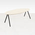 Oval oak dining table with ash white finish and V-frame design, showcasing smooth surface and elegant craftsmanship.