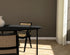 Oval oak dining table with a charcoal finish and cross frame design, showcasing the sleek wooden surface and sturdy base.