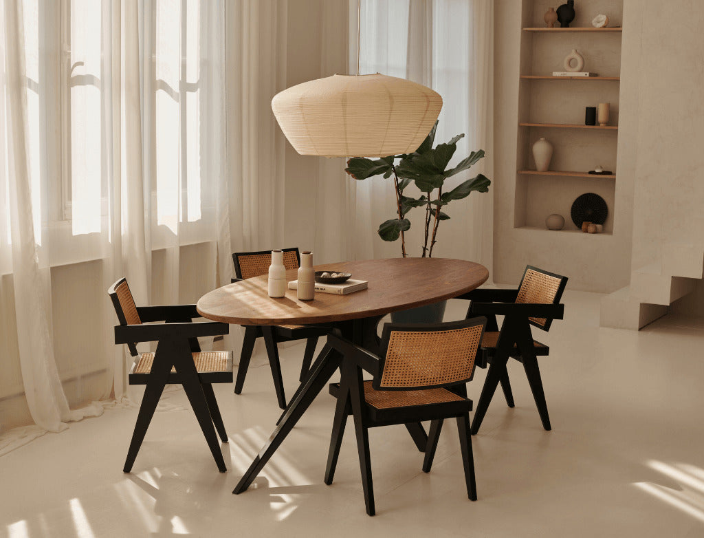 Smoked oval oak dining table with arched frame, showcasing smooth wood surface and elegant design in a modern dining room setting.