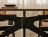 Smoked oval oak dining table with arched frame, showcasing a sleek, modern design perfect for contemporary dining rooms.