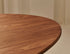Oval Walnut Dining Table with arched frame, showcasing smooth wooden surface and elegant design for modern dining rooms.