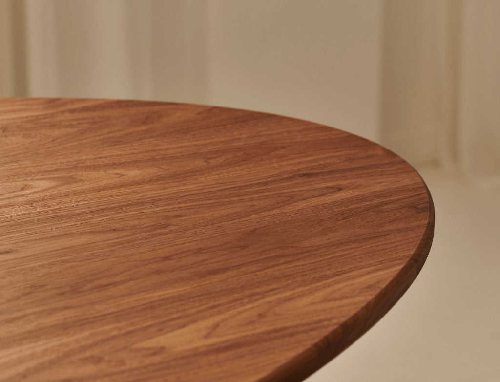 Oval Walnut Dining Table with arched frame, showcasing smooth wooden surface and elegant design for modern dining rooms.