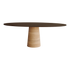 Flow dining table oval in smoked oak with travertine cylinder base, showcasing a sleek, modern design and smooth oval surface.