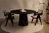 Flow round dining table with Amarante violet marble top and black cylindrical base, modern and stylish for contemporary dining spaces.