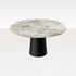 Flow round dining table with Arabescato marble top and black cylindrical base, modern design, from My Store.