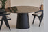 Flow round dining table with Portoro marble top and black cylindrical base, modern design by My Store.